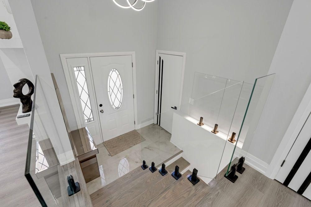Front entry with frameless glass stair railings