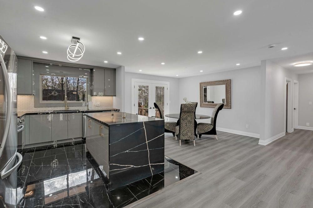 Kitchen and dining area with marble-look floor tile and a garden door
