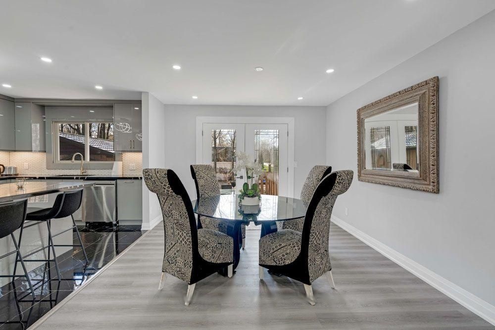 Dining area with a round glass table beside the kitchen