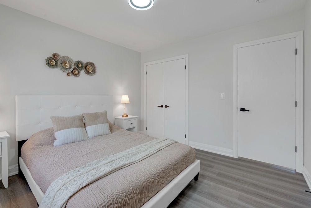 Bedroom with double closet doors and new flooring