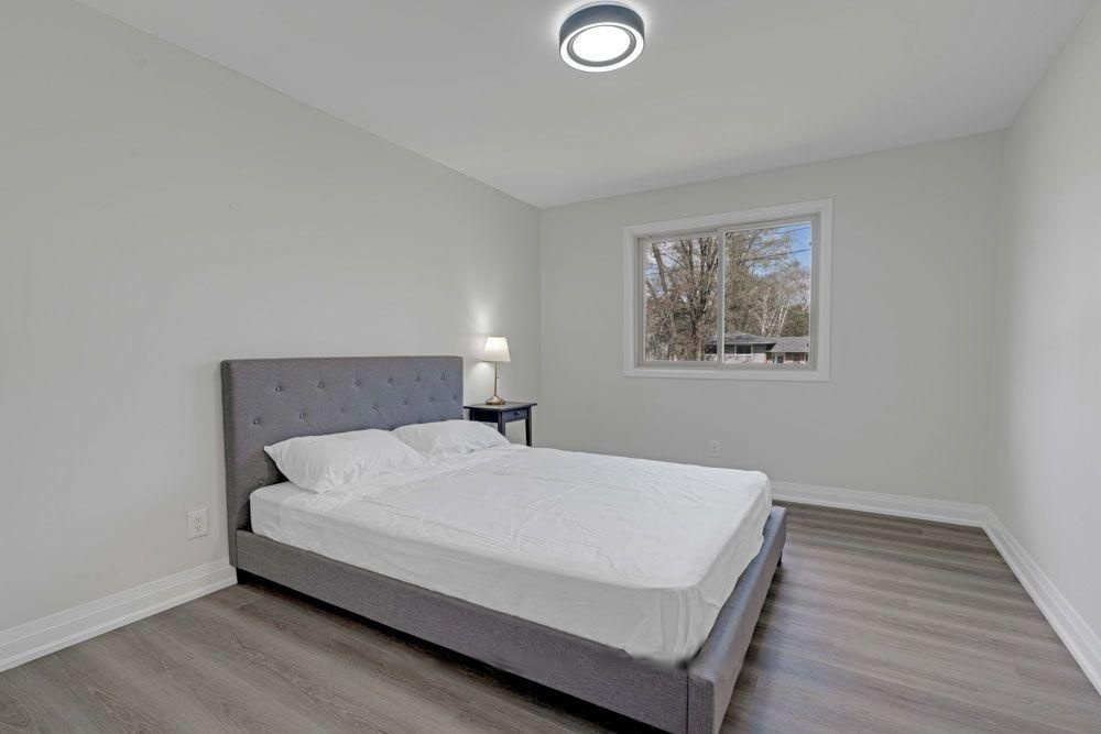 Second bedroom with a window overlooking the trees