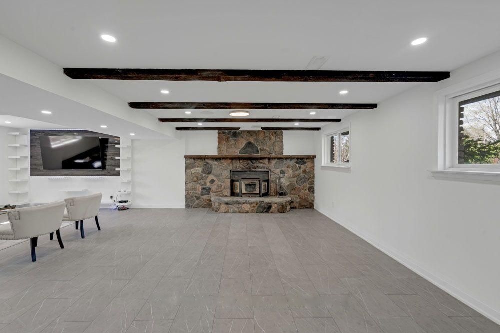 Lower level with the original stone fireplace and timber beams